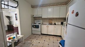 Toronto (Wexford-Maryvale) apartment for rent - A kitchen with white cabinets and a white fridge.