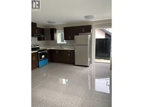Vancouver apartment for rent - A kitchen with brown cabinets and a white fridge.