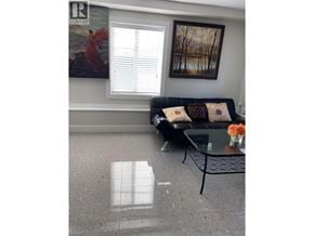 Vancouver apartment for rent - A living room with a couch, a coffee table, and a painting on the wall.