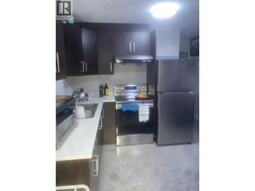 Vancouver apartment for rent - A kitchen with a sink, stove, and refrigerator.