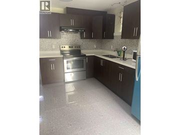 Vancouver apartment for rent - A kitchen with a stove top oven and a dishwasher.