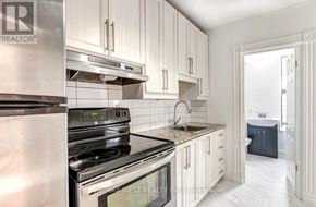 Toronto (Junction Area) apartment for rent - A kitchen with white cabinets and stainless steel appliances.