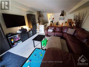 Ottawa townhouse for rent - A living room with a brown couch and a television.