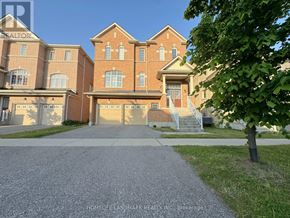 Markham (Wismer) apartment for rent - A large brick house with a driveway in front.