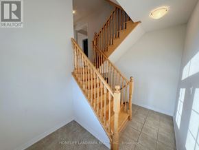 Markham (Wismer) apartment for rent - A wooden staircase with a white wall on the side.