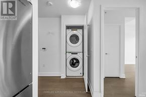 Toronto (Mimico) condo for rent - A white laundry room with a washer and dryer built into the wall.