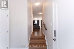 Ottawa townhouse for rent - A hallway with a door on the left and a staircase on the right.