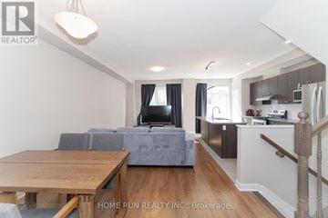 Ottawa townhouse for rent - A living room with a grey couch and a wooden table.