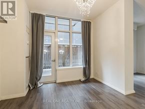 Toronto (Church-Yonge Corridor) condo for rent - A room with a large window and a chandelier.