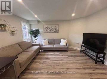 Markham (Box Grove) apartment for rent - A living room with a grey sofa and a wooden floor.