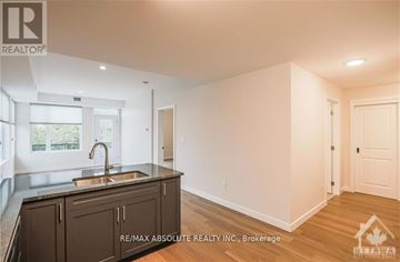 Ottawa apartment for rent - A kitchen with a sink and cabinets in a room with a white wall.