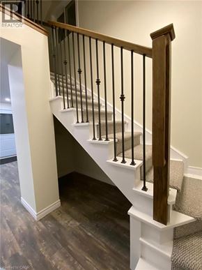 Hamilton apartment for rent - A staircase with a wooden handrail and white risers.