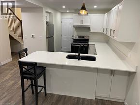 Hamilton apartment for rent - A kitchen with a white countertop and black bar stools.