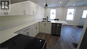 Hamilton apartment for rent - A modern kitchen with a stove top oven and a refrigerator.