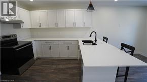 Hamilton apartment for rent - A kitchen with white countertops and black appliances.