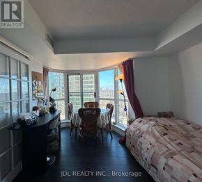 Toronto (Rosedale-Moore Park) condo for rent - A bedroom with a large bed and a desk with a chair in front of a window.