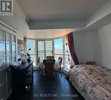 Toronto (Rosedale-Moore Park) condo for rent - A bedroom with a large bed and a desk with a chair in front of a window.