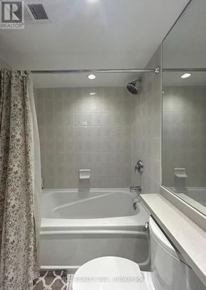 Toronto (Rosedale-Moore Park) condo for rent - A white bathroom with a tub, toilet and sink.