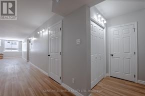North Stormont fourplex for rent - A hallway with white doors and wooden floors.