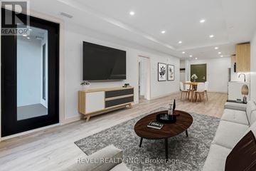 Lincoln (Beamsville) condo for rent - A modern living room with a flat screen TV and a coffee table in the center.