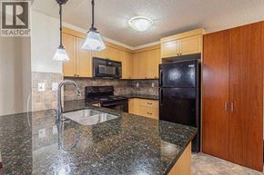 Calgary apartment for rent - A kitchen with granite countertops and wooden cabinets.