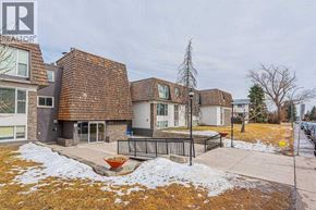 Calgary apartment for rent - A house with a brown roof and a white door is surrounded by snow.