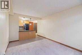 Calgary apartment for rent - A living room with a kitchenette and a television.