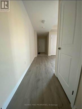 Kitchener townhouse for rent - A hallway with a white door and a white wall.