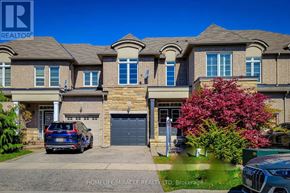 Oakville (Wm Westmount) townhouse for rent - A large, well-maintained house with a blue car parked in front.