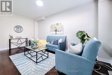 Oakville (Wm Westmount) townhouse for rent - A living room with a blue couch and a coffee table.