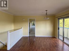 Richmond apartment for rent - A room with wooden floors and a sliding glass door leading to a balcony.