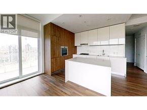 Burnaby apartment for rent - A modern kitchen with white countertops and wooden cabinets.