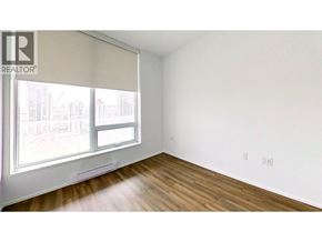 Burnaby apartment for rent - A room with a window and wooden floors.