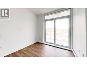 Burnaby apartment for rent - A room with a large window and wooden flooring.