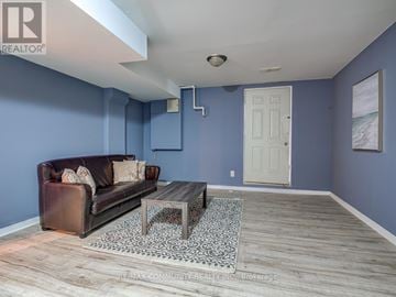 Toronto (Malvern) apartment for rent - A living room with a brown leather couch and a coffee table.
