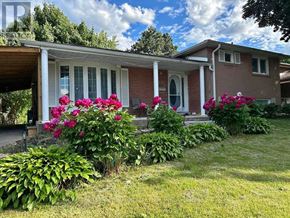 Toronto (Woburn) apartment for rent - A house with a red brick exterior and a porch with white columns.