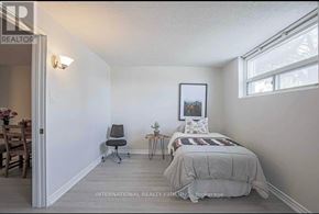 Toronto (Woburn) apartment for rent - A bedroom with a bed, chair, and a painting on the wall.