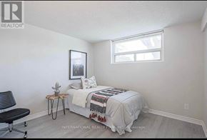 Toronto (Woburn) apartment for rent - A bedroom with a bed, chair, and a picture on the wall.