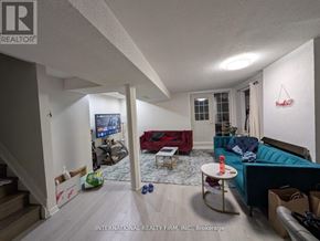 Toronto (Woburn) apartment for rent - A living room with a couch, a television, and a coffee table.