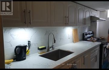 Toronto (Woburn) apartment for rent - A kitchen with a sink, a coffee maker, and a cutting board.