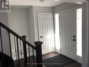 Georgian Bay (Baxter) house for rent - A hallway with a black railing and two white doors.