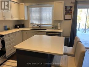 Georgian Bay (Baxter) house for rent - A kitchen with a table and chairs in front of it.