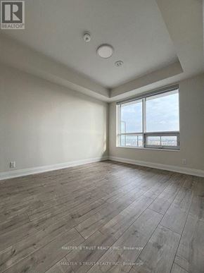 Markham (Unionville) condo for rent - A room with wooden flooring and a large window.
