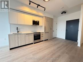Toronto (Centennial Scarborough) condo for rent - A kitchen with wooden cabinets and a black oven.