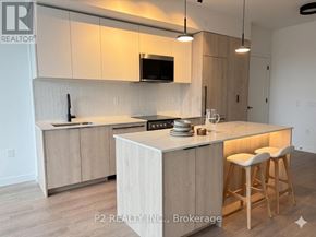 Toronto (Centennial Scarborough) condo for rent - A modern kitchen with wooden cabinets and a central island.