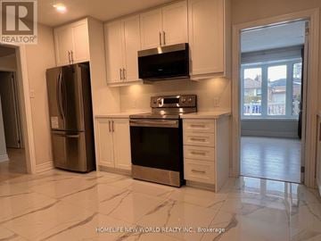 Bradford West Gwillimbury (Bradford) apartment for rent - A kitchen with white cabinets and a black microwave above the stove.