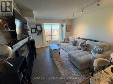 Toronto (Banbury-Don Mills) condo for rent - A living room with a grey couch and a flat screen TV.