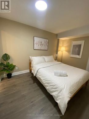 Markham (Village Green-South Unionville) apartment for rent - A bedroom with a bed, a potted plant, and two framed pictures on the wall.