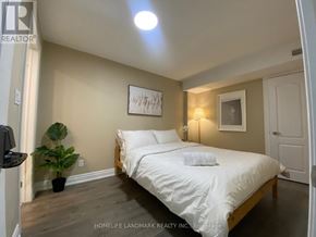 Markham (Village Green-South Unionville) apartment for rent - A bedroom with a bed, a potted plant, and a painting on the wall.