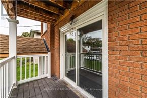 Brantford duplex for rent - A balcony with a glass door and a white railing.
